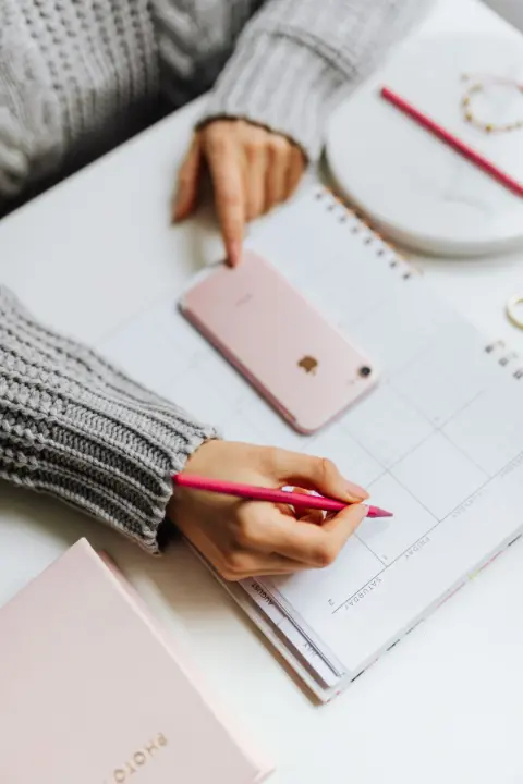 A person planning out a schedule on paper